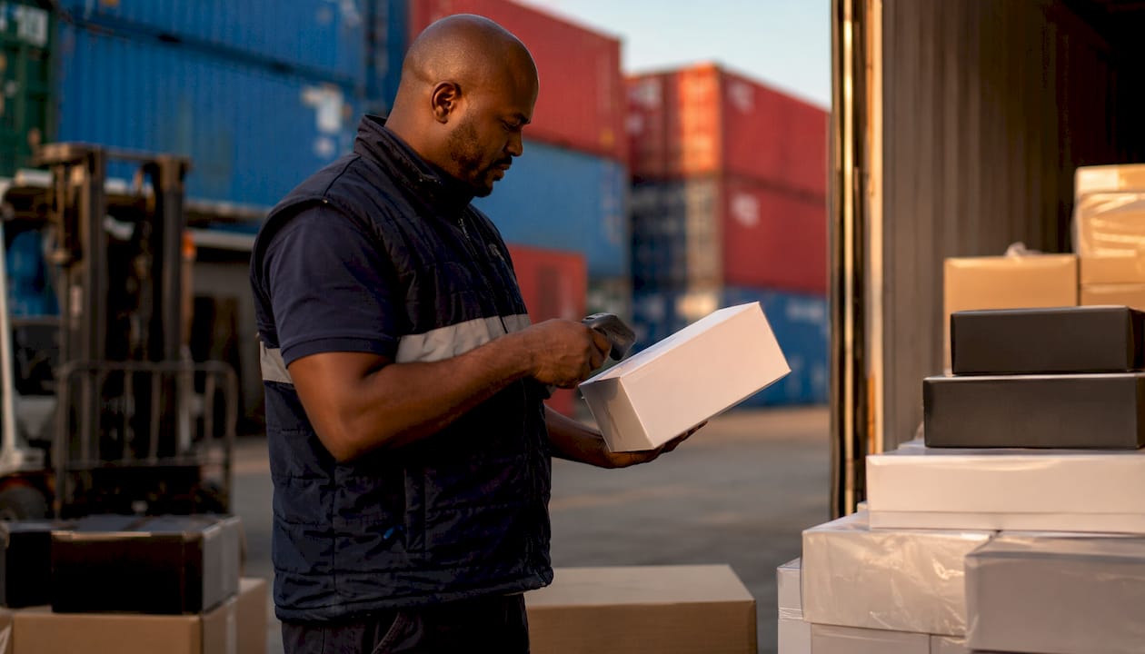 Hands scanning luxury shipment package label