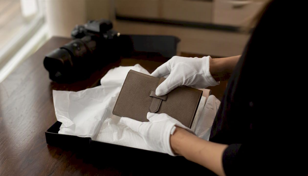 Hands photographing luxury item before shipping