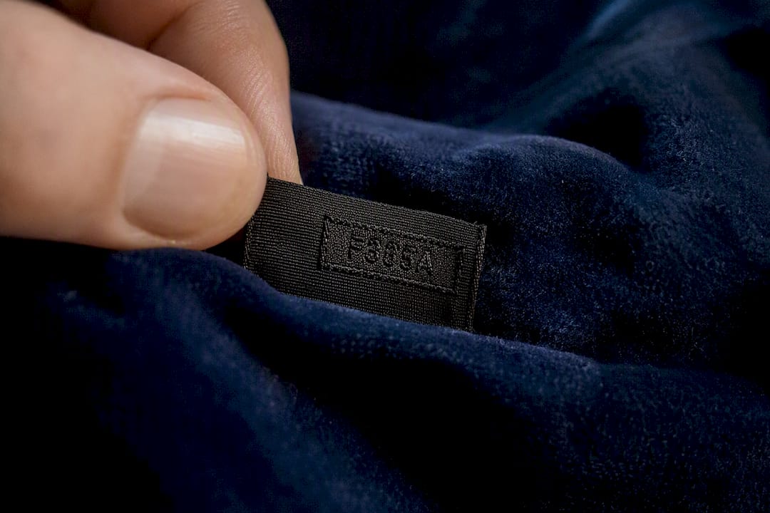 Close-up of black fabric tag and year code