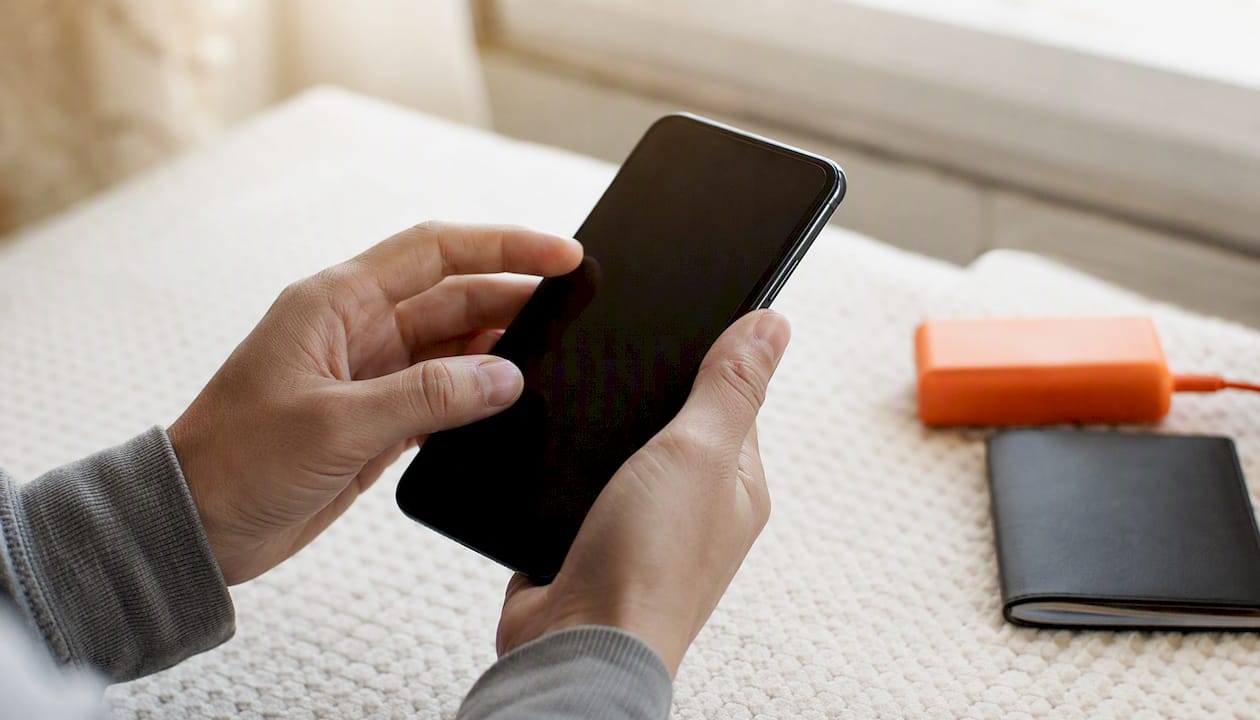 Hands adjusting phone network settings