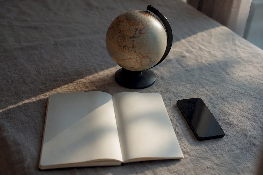 Travel accessories and smartphone on gray surface