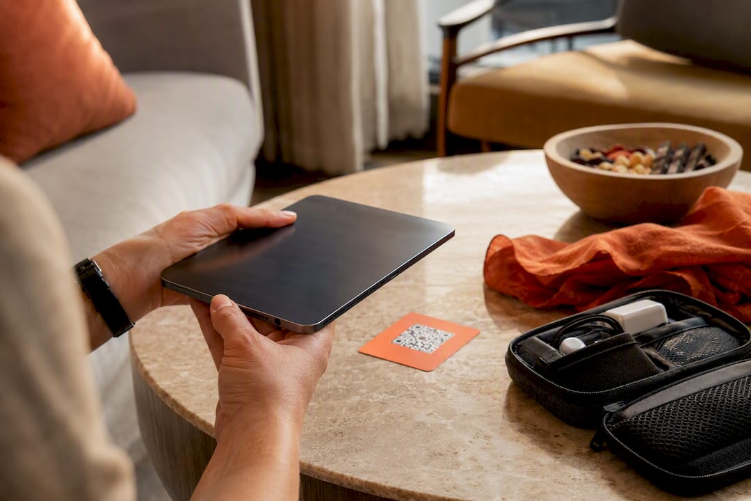Hands holding tablet tablet activating eSIM via QR code