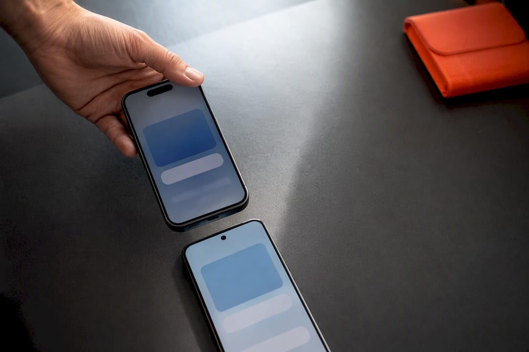 Hands transferring eSIM between phones