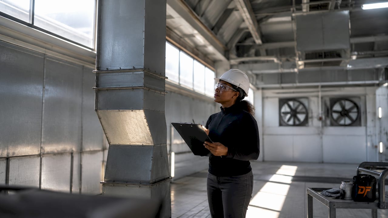 Engineer inspecting paint booth duct system
