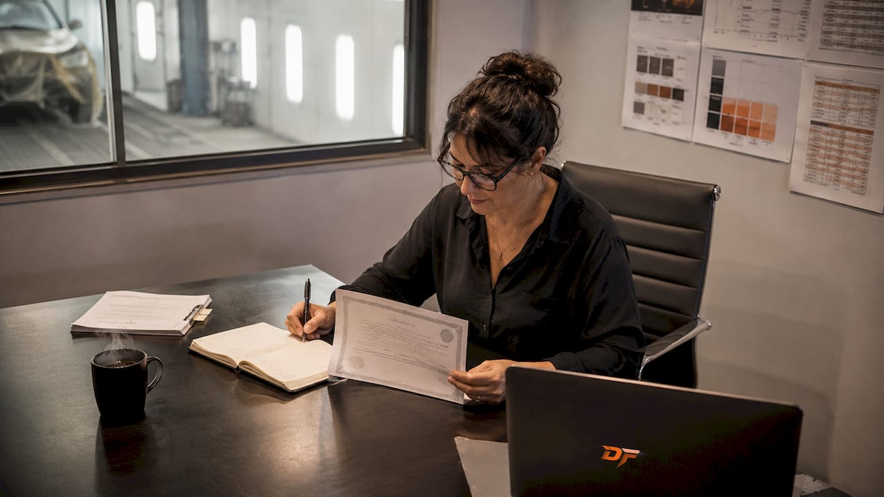 Facility manager reviewing paint booth warranty documents