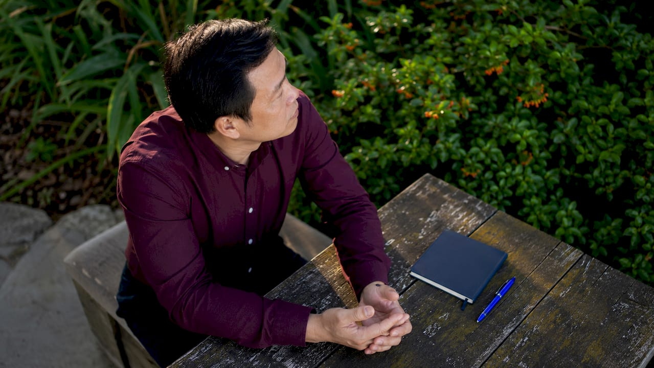 Man reflecting quietly on park bench