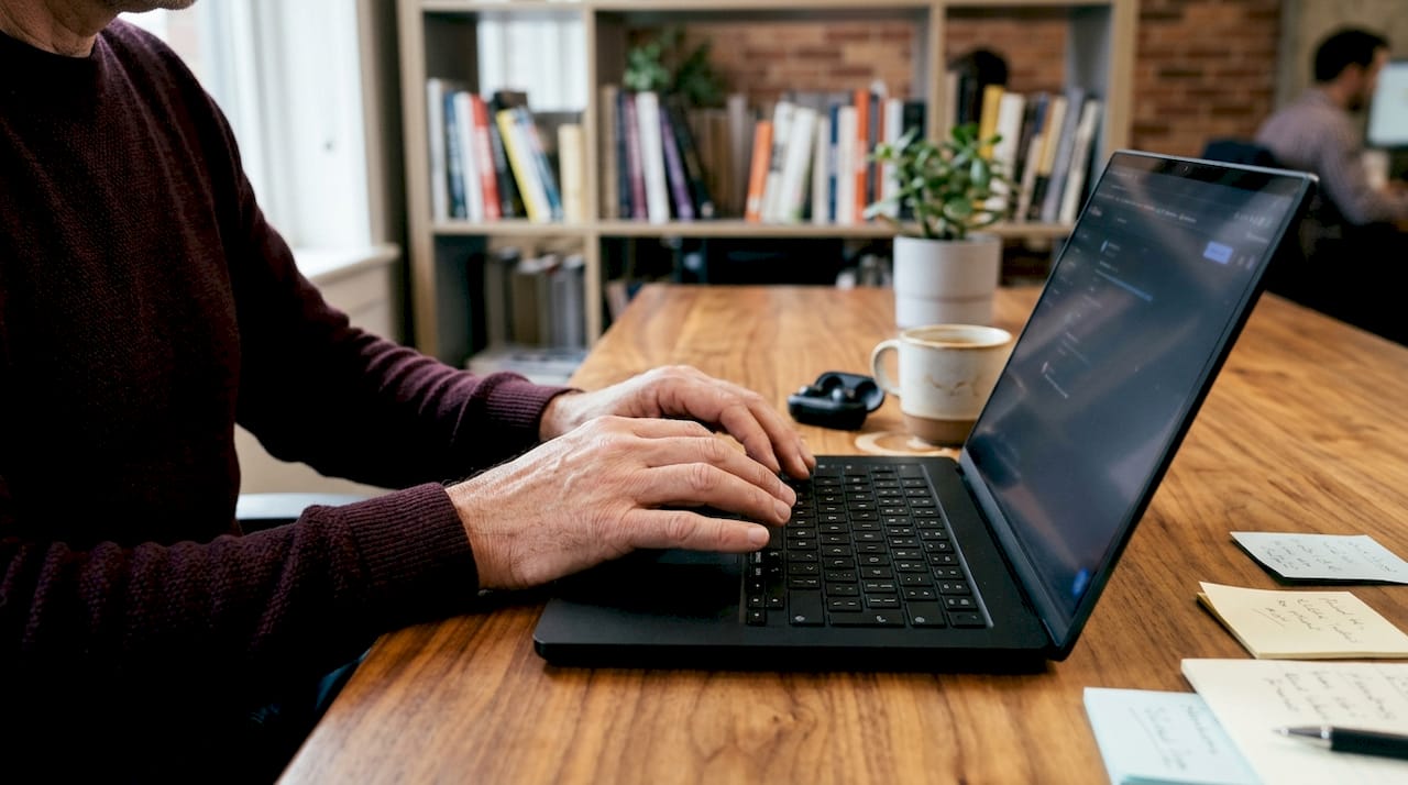 Hands typing on laptop during therapy tech setup