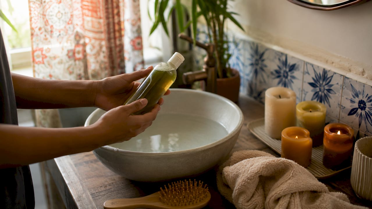 Hands preparing hair with shampoo before collection