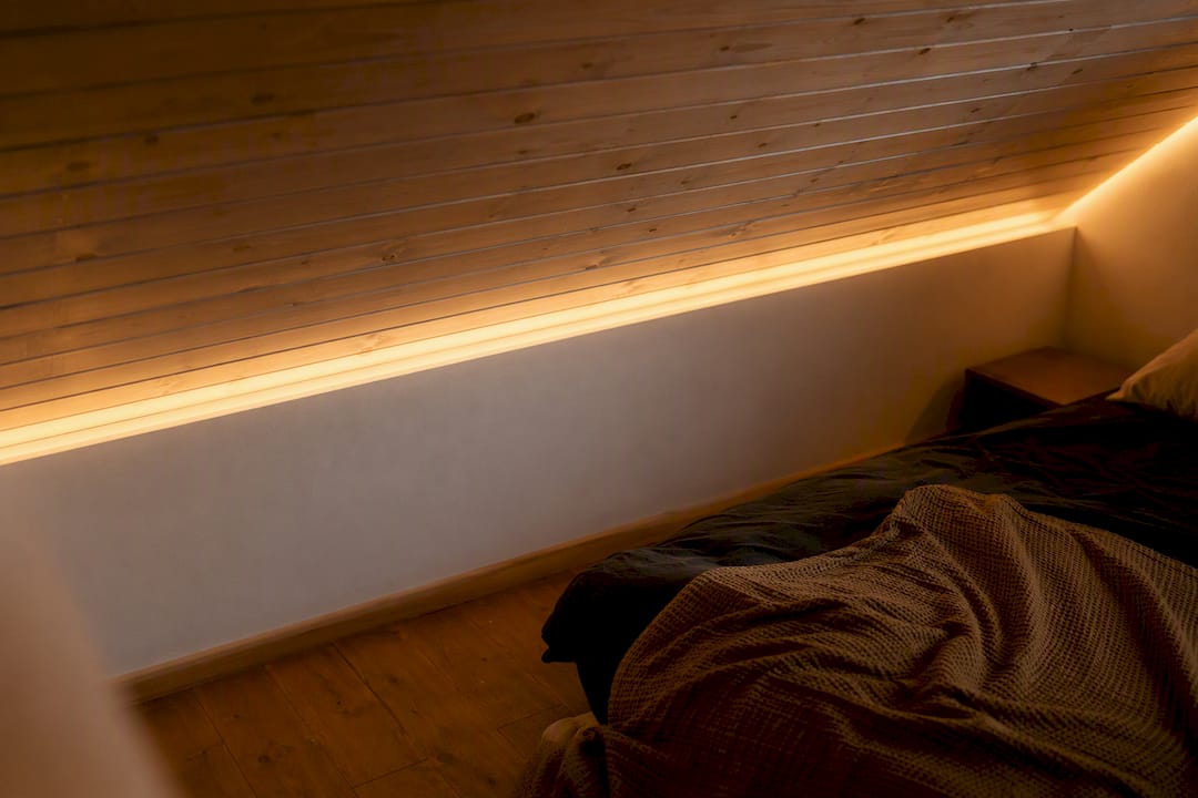 Indirekte, warmweiße LED-Beleuchtung entlang der Dachschräge sorgt für eine gemütliche Atmosphäre im Dachgeschoss.