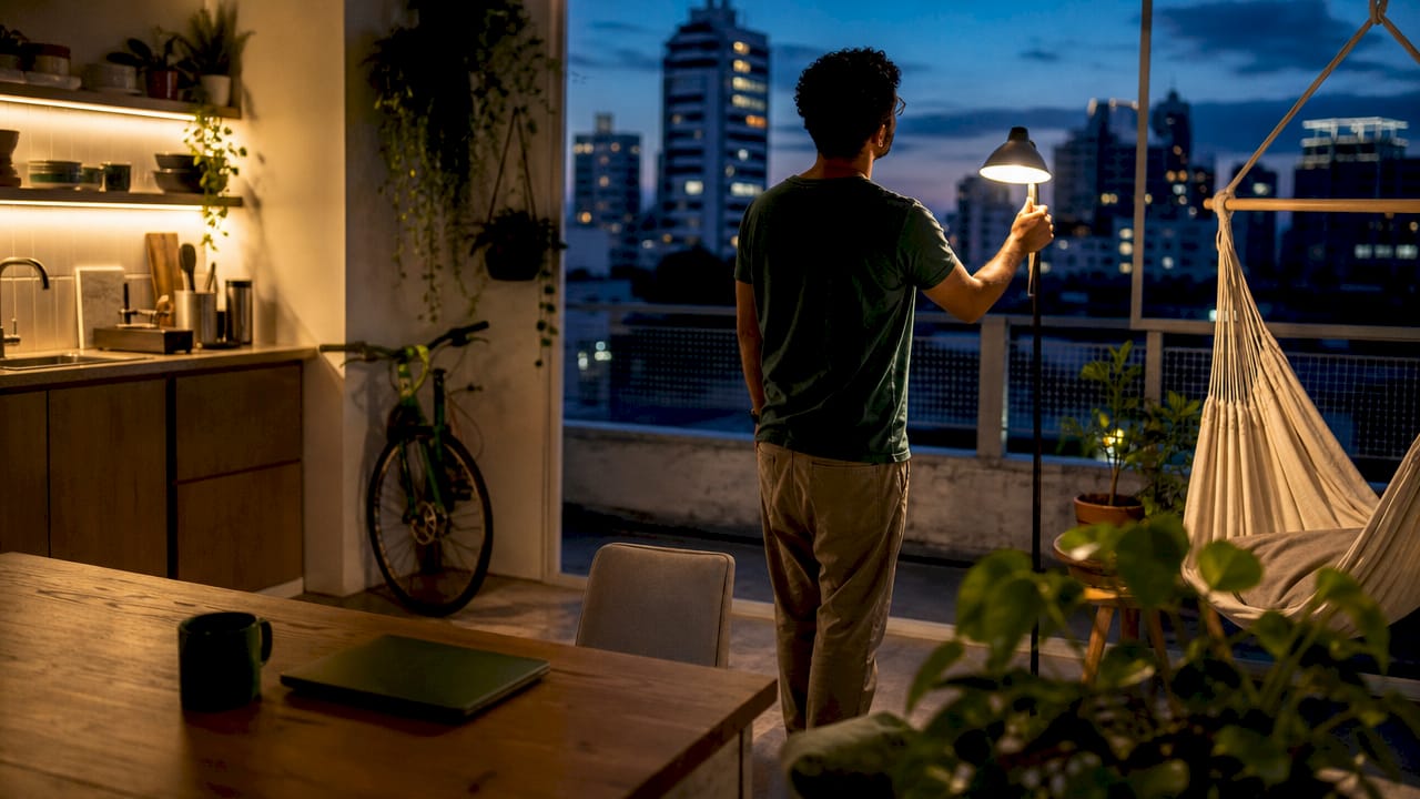 Man arranging workspace in studio apartment