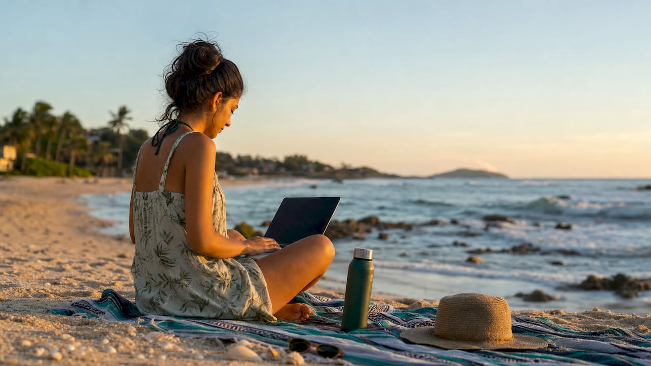 Woman working remotely in tropical hostel