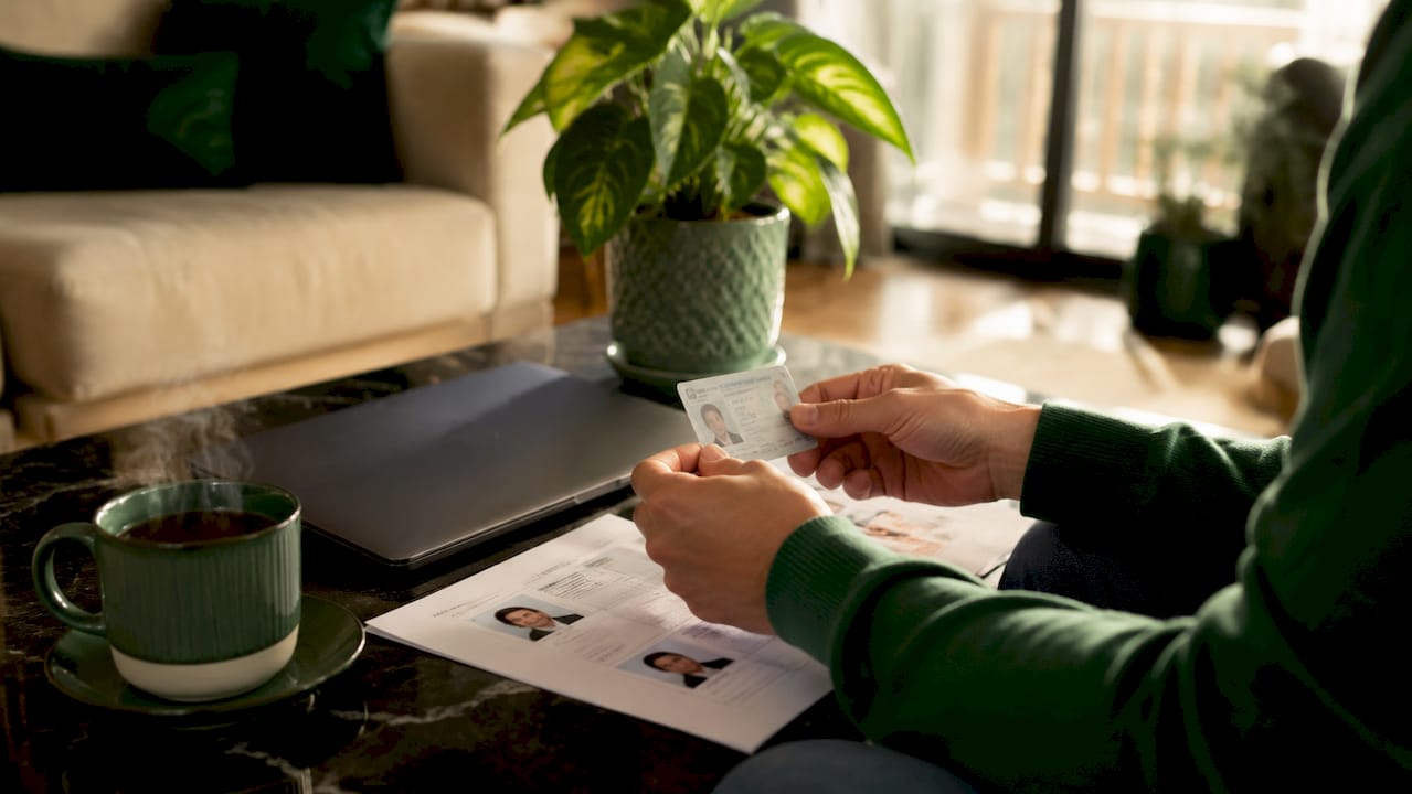 Hands verifying government ID against profile details