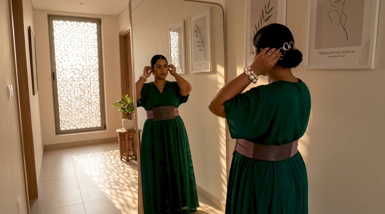 Woman checking bold accessory outfit at home