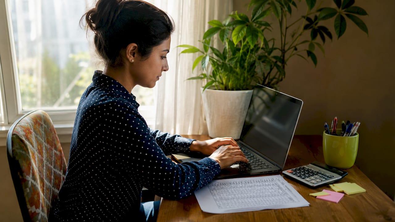 Hands working on refinancing financial analysis