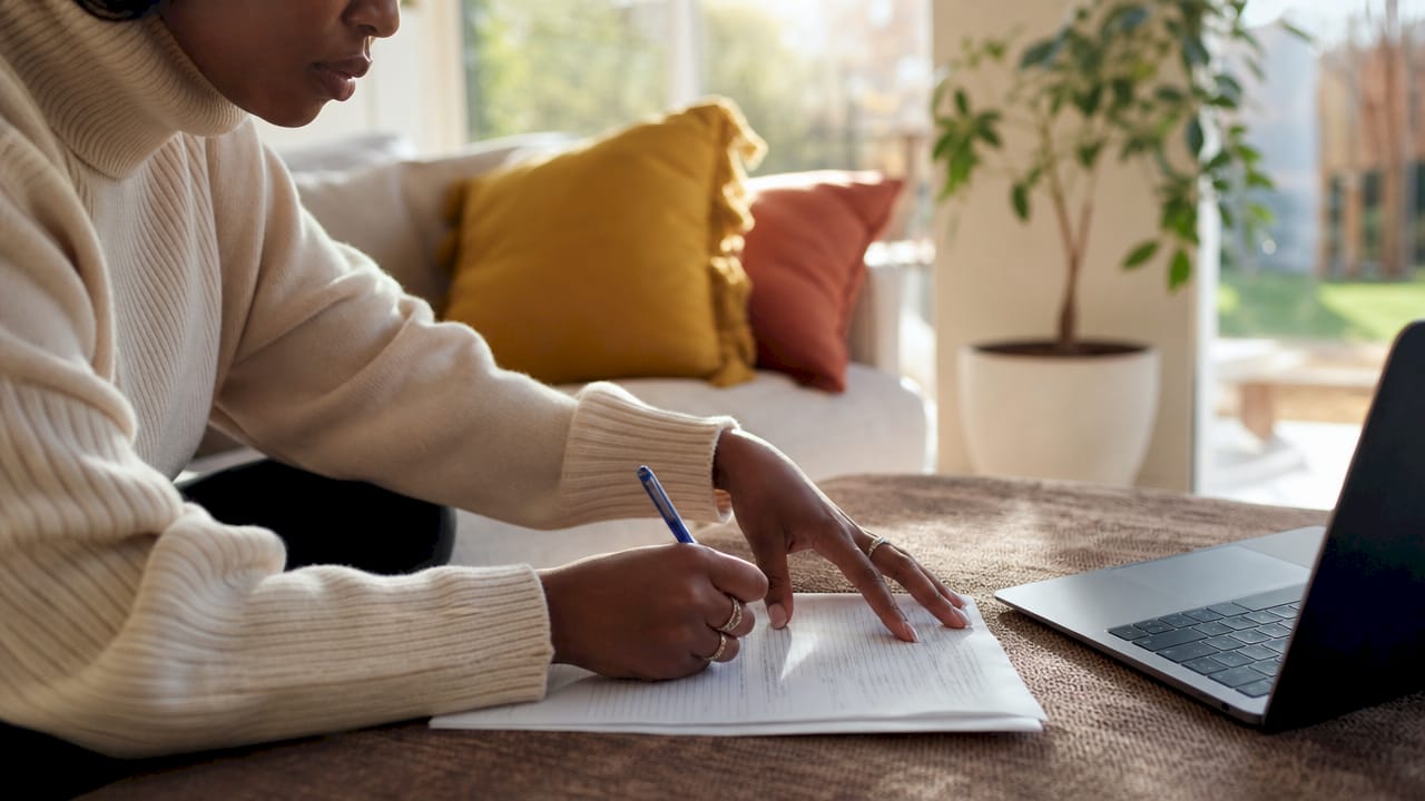 Hands calculating credit scores on loan documents
