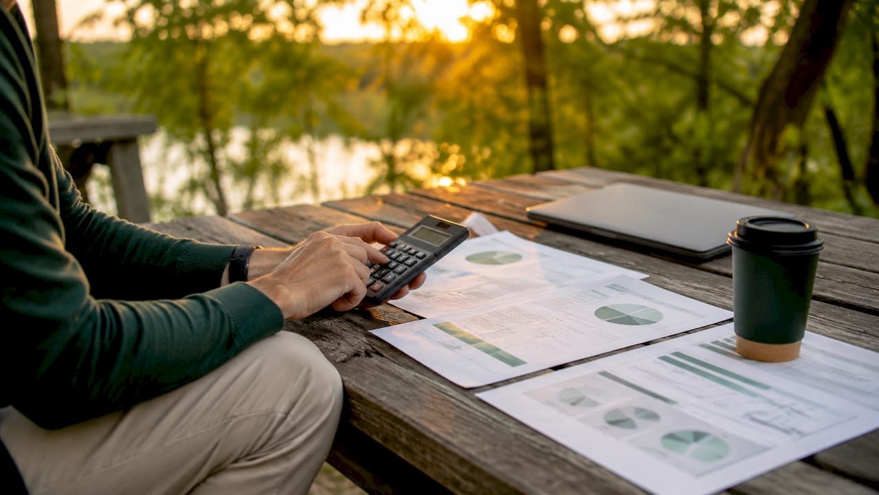 Hands calculating eco blends economic benefit analysis