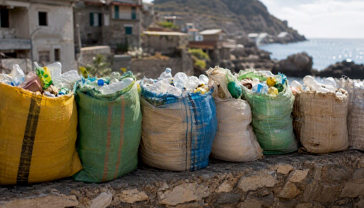 Plastic collection bags in coastal village
