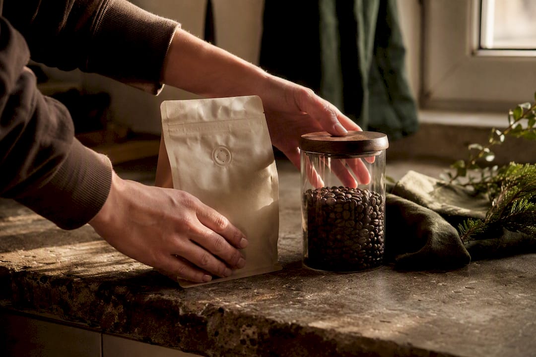 Hands comparing coffee freshness and sustainability options