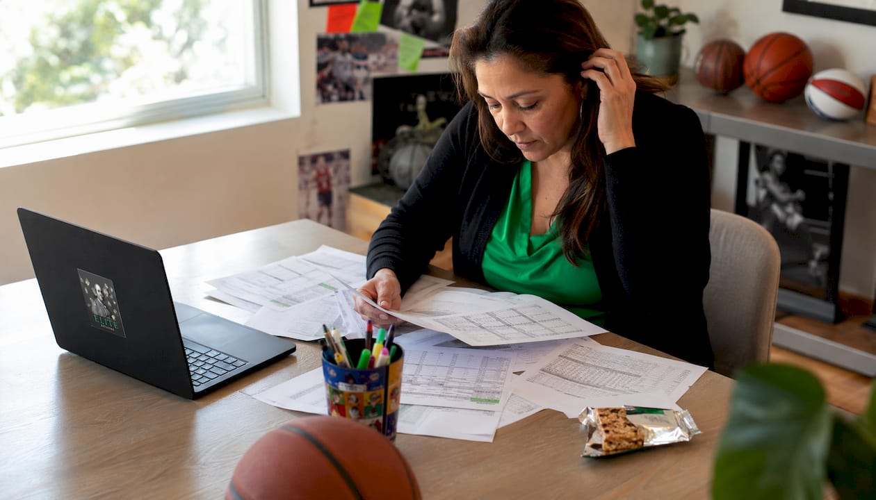 Woman reviewing point spread betting lines on board