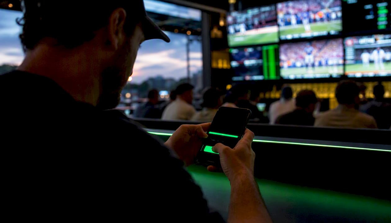 Hand about to tap cash-out button on phone