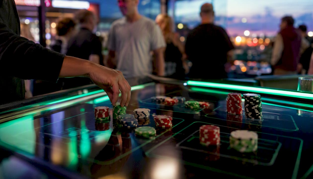 Hand stacking chips on multi-leg parlay ticket