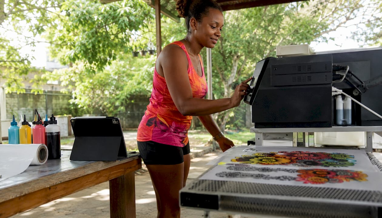 Technician operating DTF printer in workshop