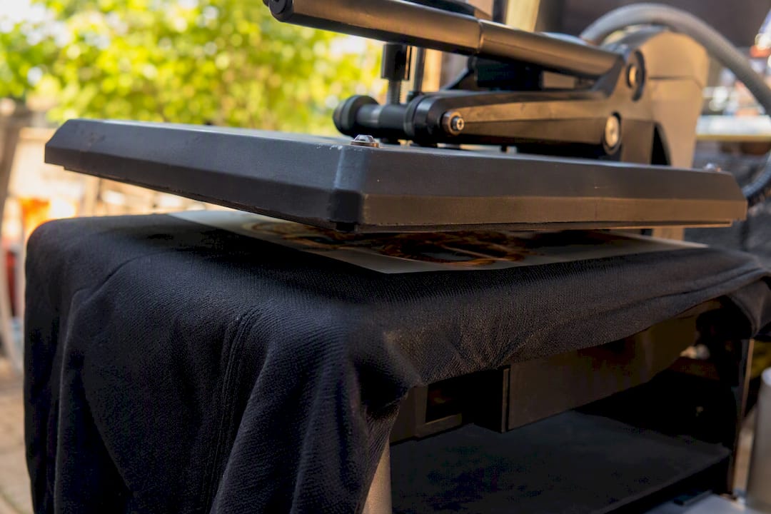 Heat press applying even pressure to transferred fabric