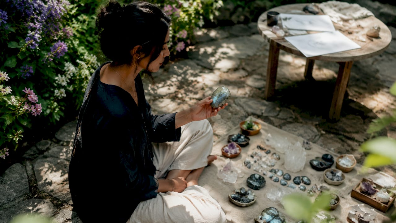 Woman holding amethyst in home studio