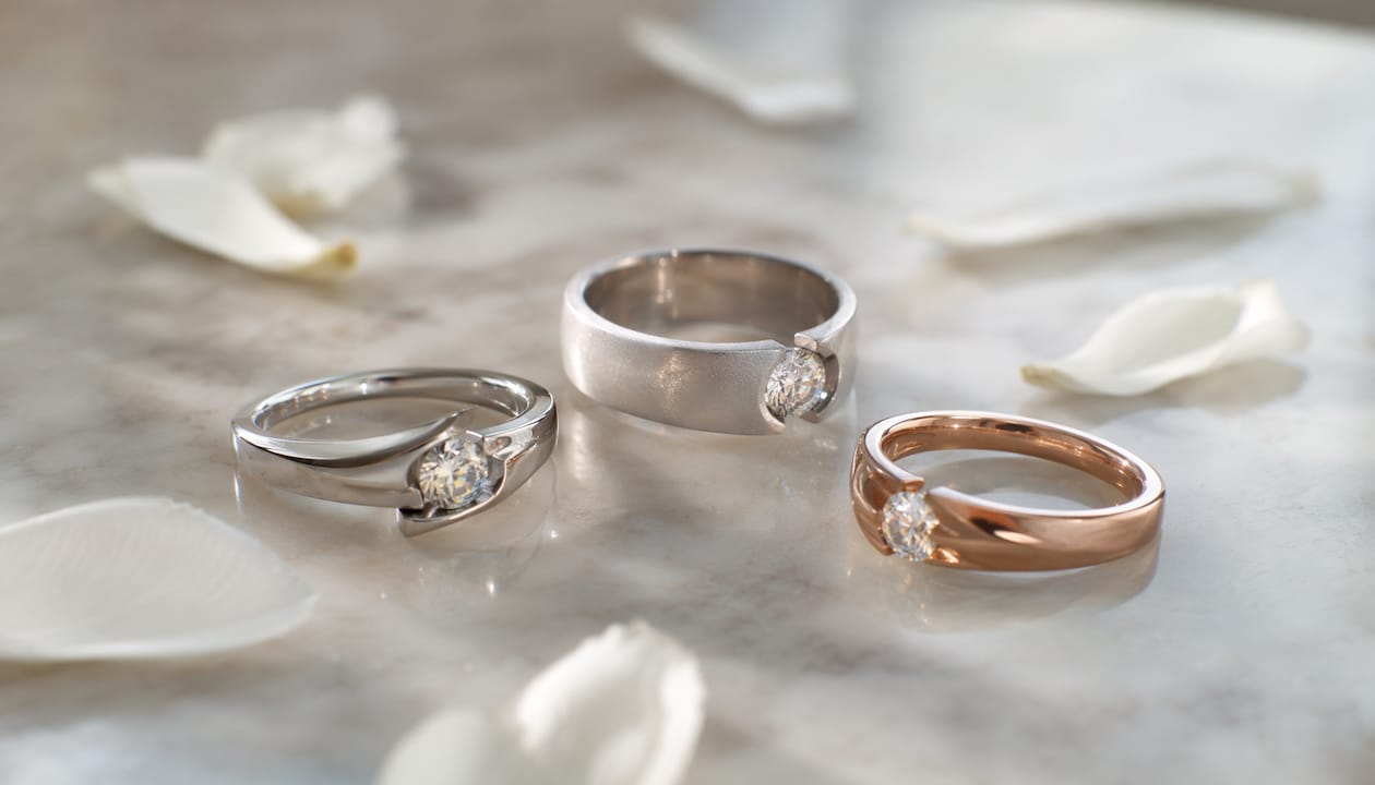 Flat lay of varied floating diamond ring styles