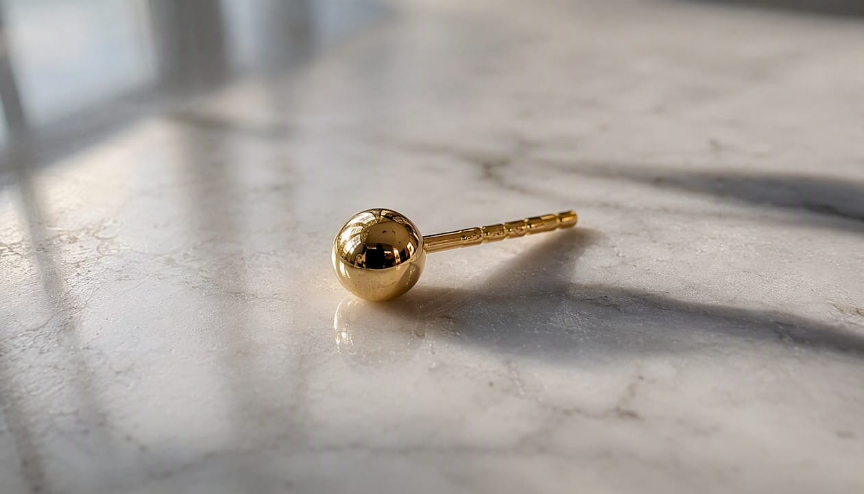 Classic gold 4mm stud earring close-up