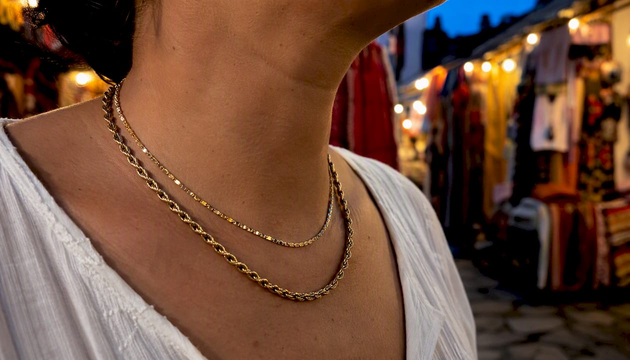 Layered light and heavy necklaces on neck