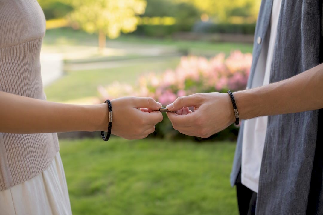 Hands linking magnetic bracelets