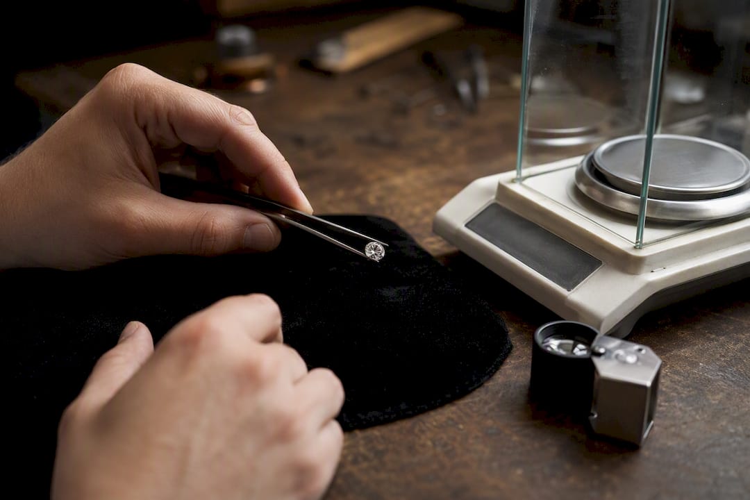 Gemologist preparing gemstone for testing
