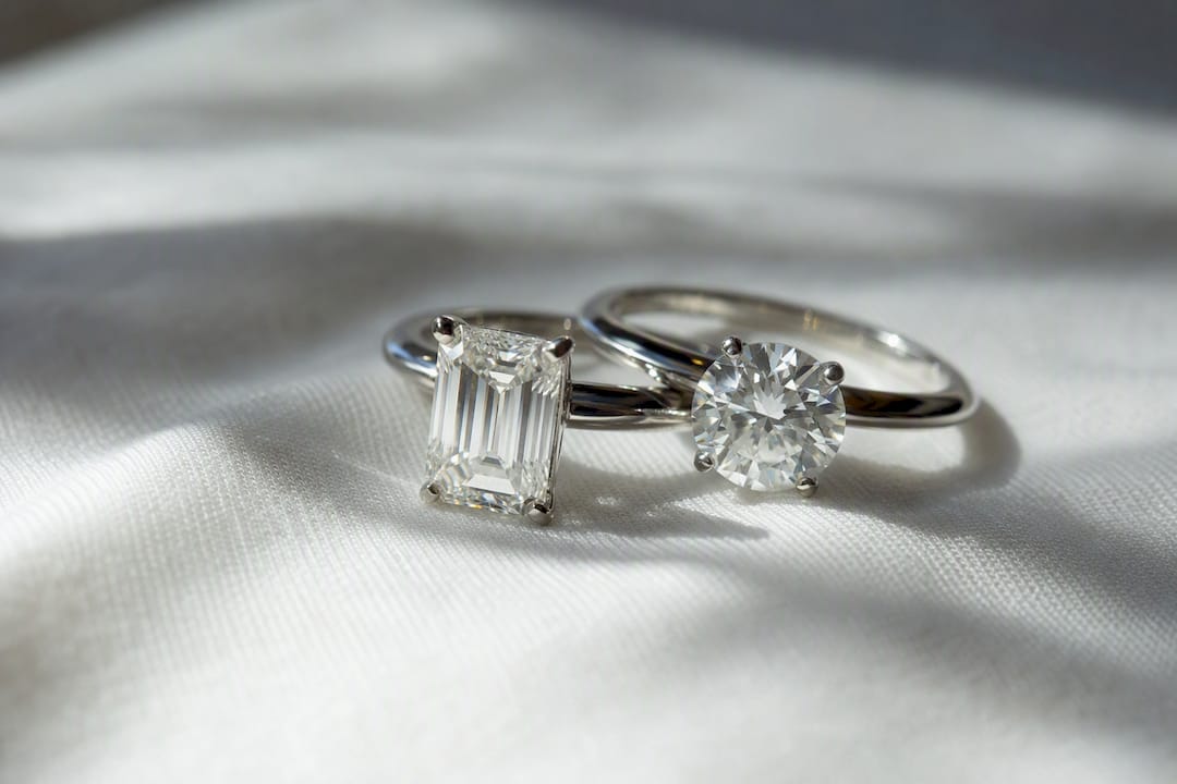Emerald cut and round brilliant diamond rings close-up
