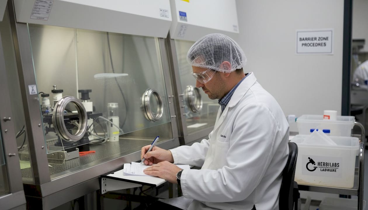 Quality manager inspecting lab isolator equipment