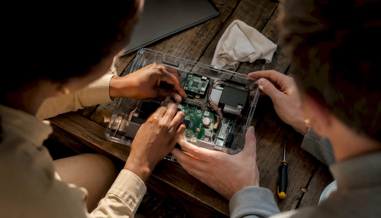 Hands assembling POS terminal components