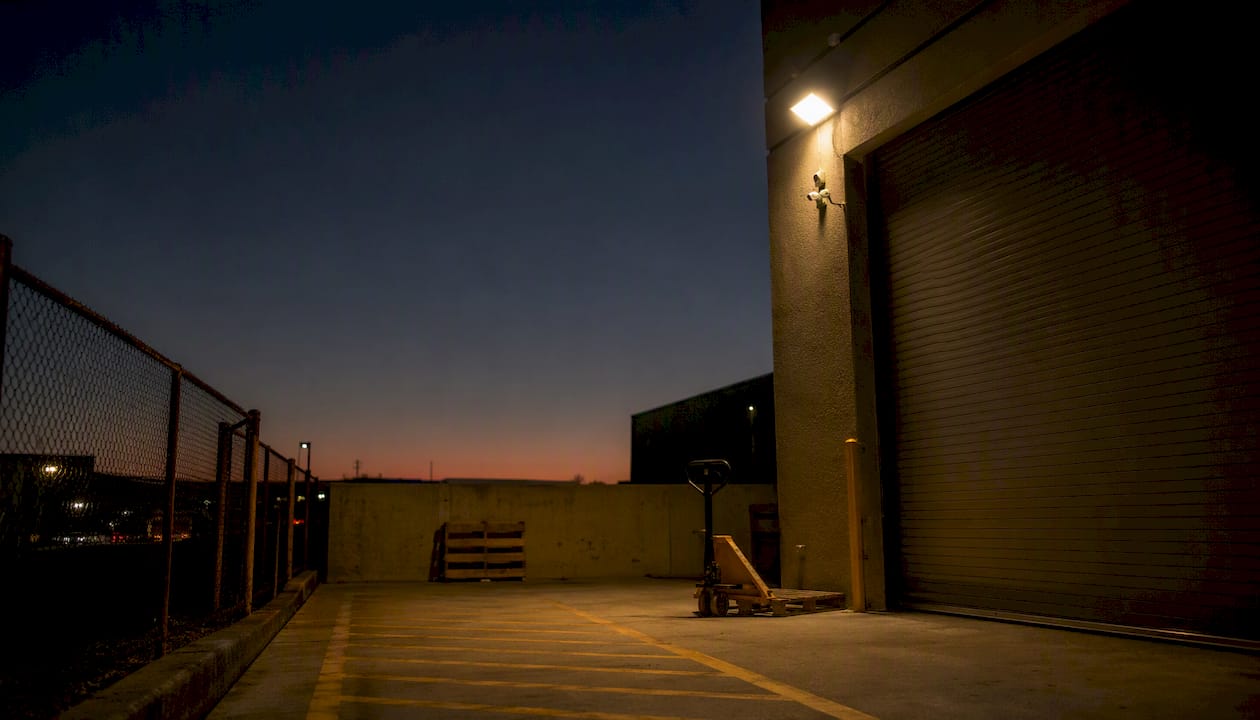 LED floodlight lit loading dock with security camera
