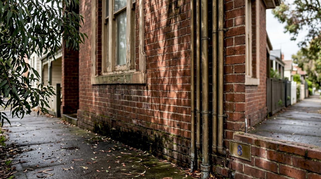 Weathered Melbourne heritage brick wall with grime