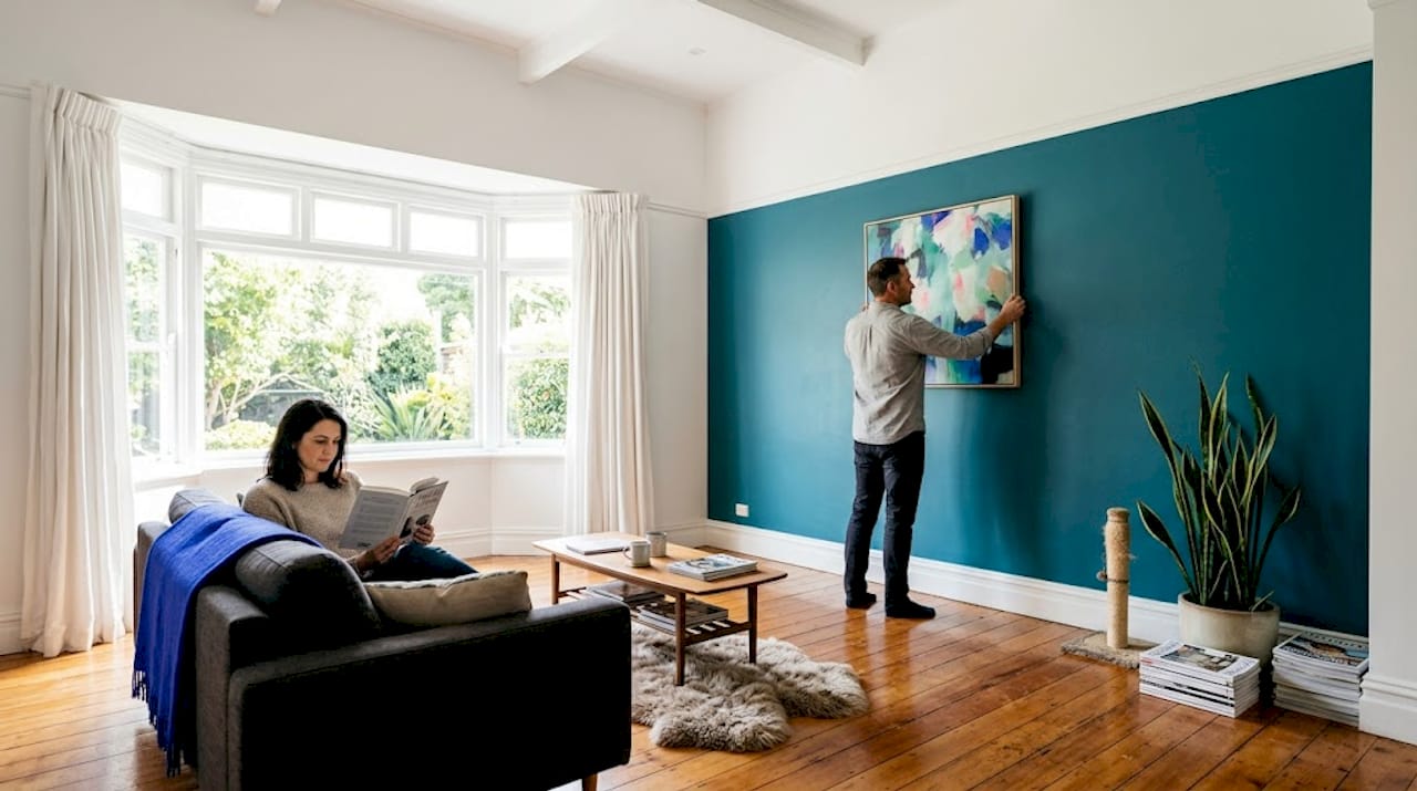 Couple relaxing in newly painted stylish living room