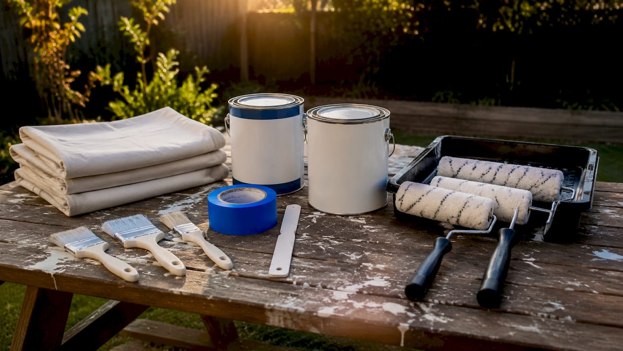 Set of painting tools and materials on workbench