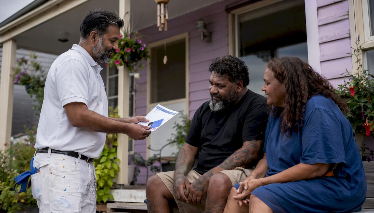 Contractor showing insurance papers to homeowners
