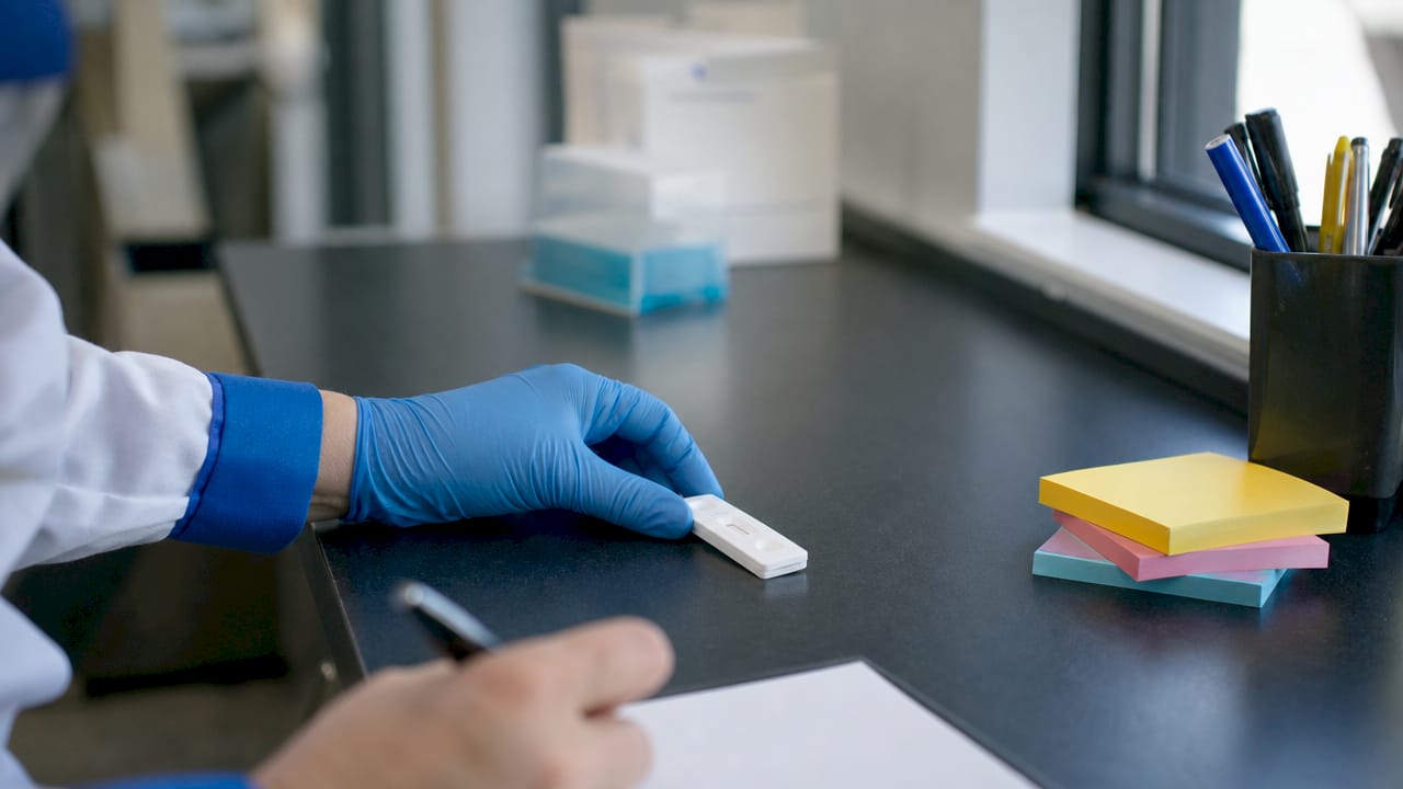 Hands inspecting rapid drug test results
