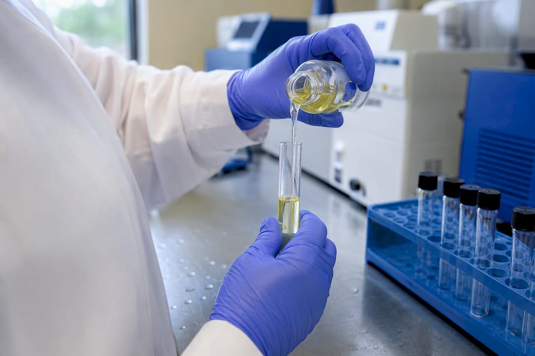Hands pipetting fentanyl test sample in lab