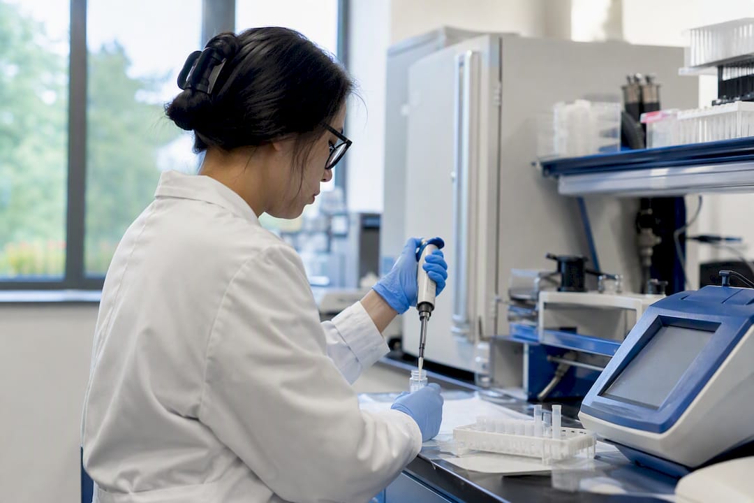 Technician preparing urine sample for lab confirmatory nitrite test