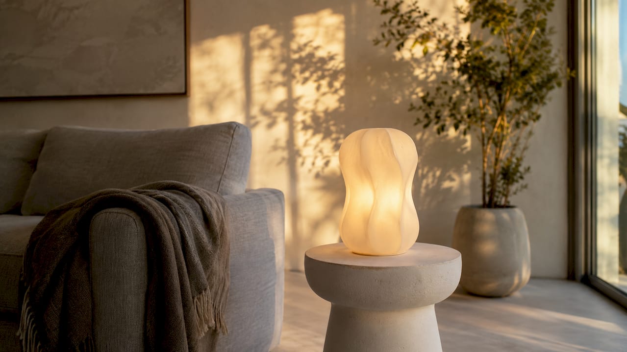 Sculptural lamp on concrete side table