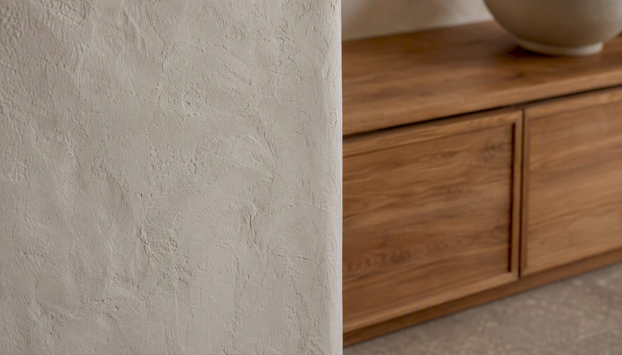 Textured limewash wall and warm wood grain detail