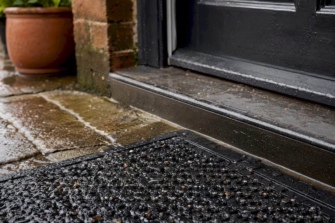 Rubber mat shedding rain and grit