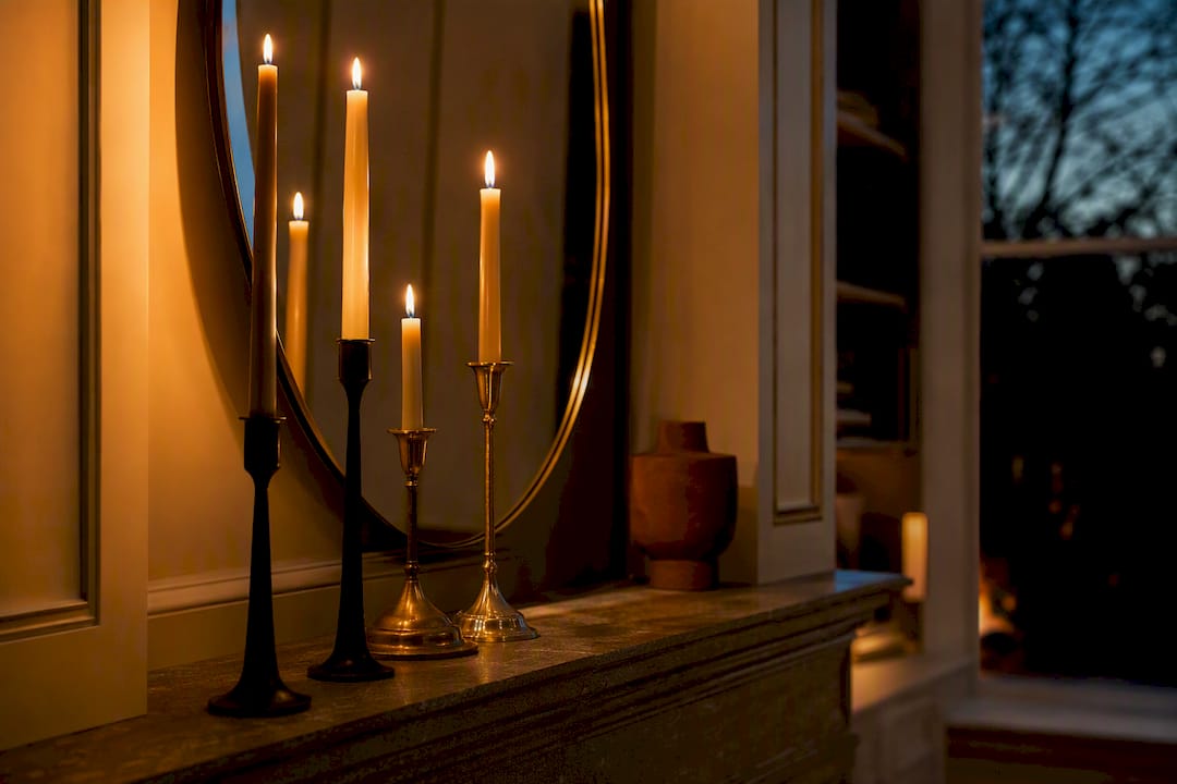 Candlelit mantel with reflected evening glow