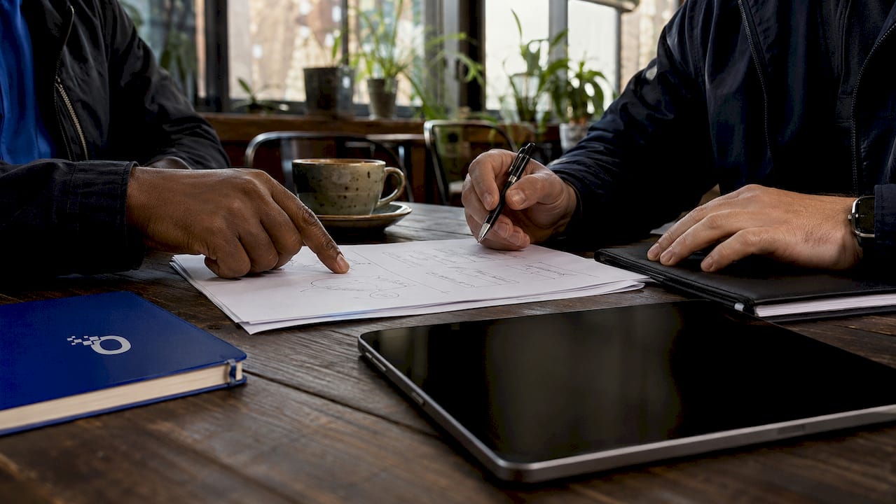 Hands discussing reputation versus brand documents