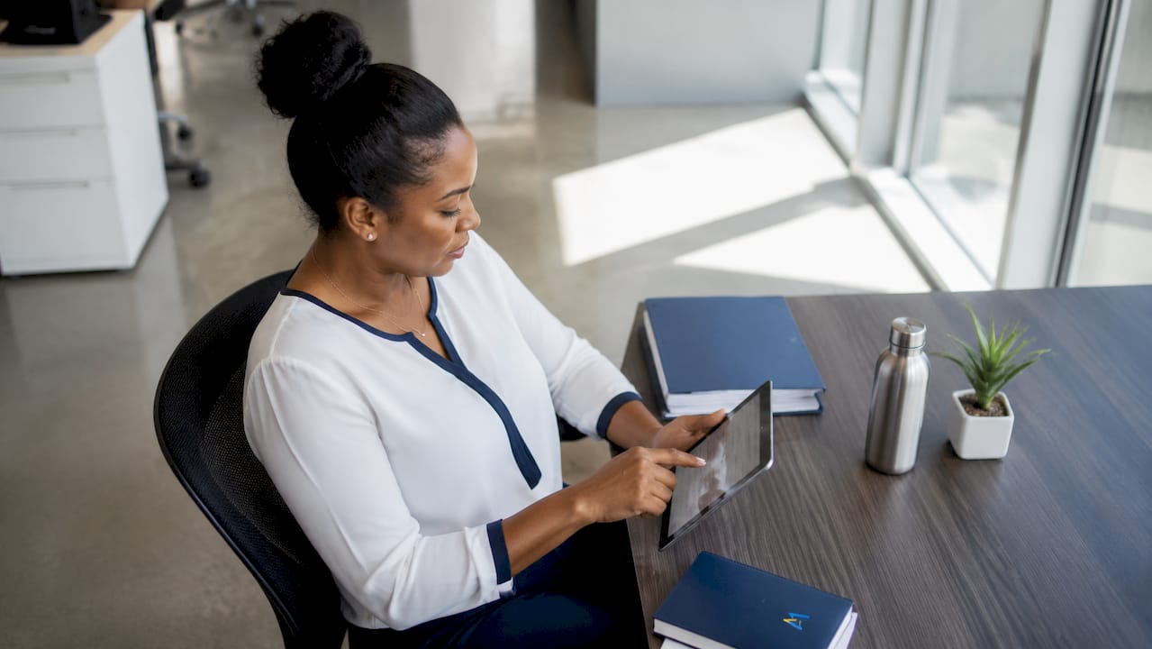 Woman managing lead intake automation on tablet